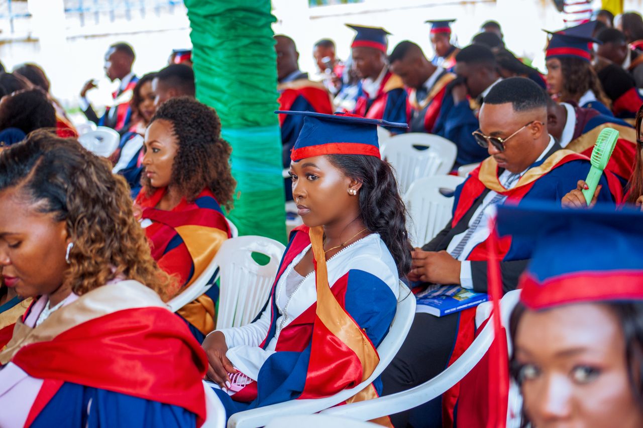Students in caps and gowns attending a graduation ceremony, showcasing diversity and education.